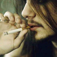 longhaired man smoking cigarette